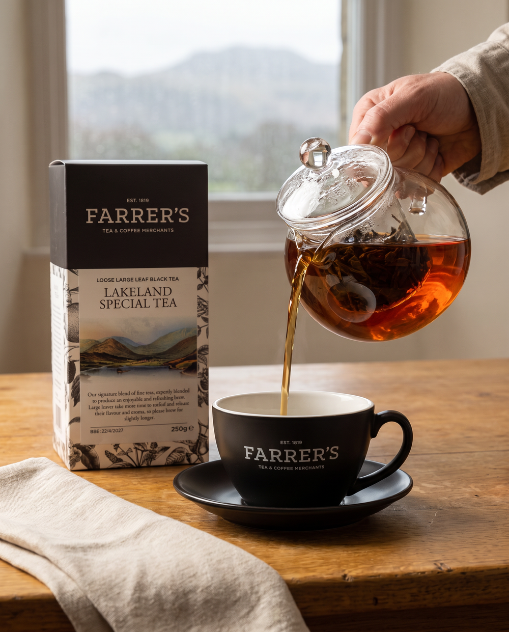 Lakeland Special loose-leaf tea poured from a clear teapot into a current Farrer's cup and saucer