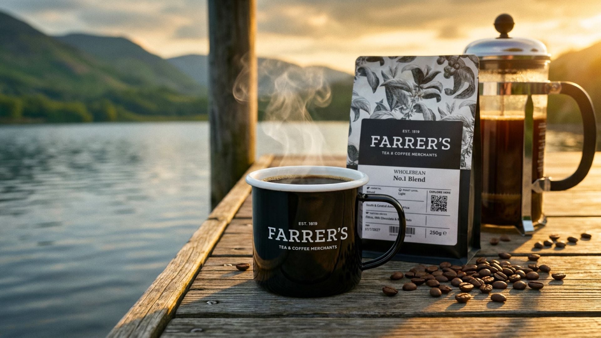 Mug, pack & cafeti&egrave;re on a pier by a Lake District lake