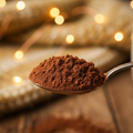 heap of hot chocolate on a teaspoon with a cozy background 