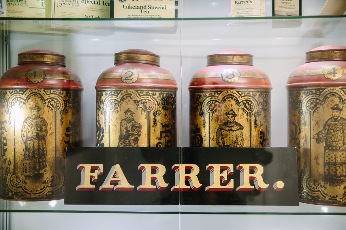 Historic Farrer's tea and coffee tins on a shelf at the Kendal premises