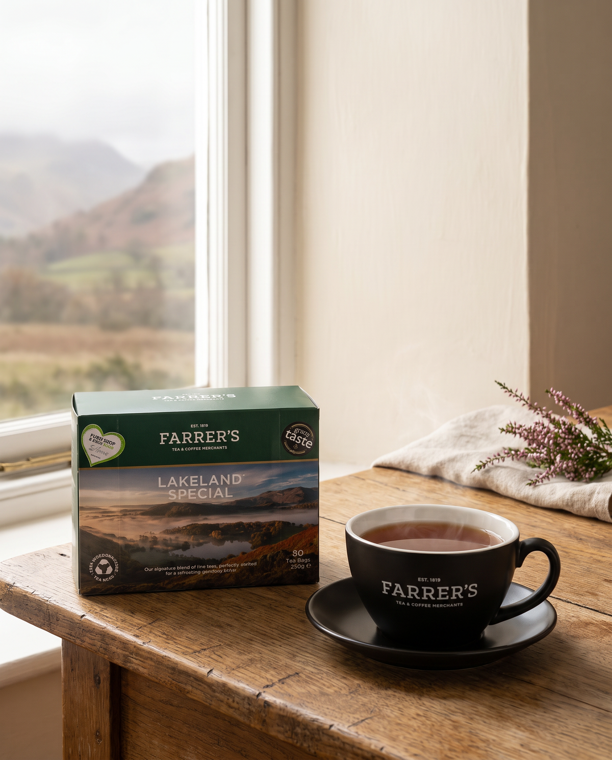 A box of Farrer's Lakeland Special tea bags beside a cup of brewed tea